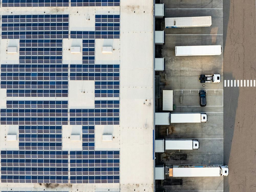 Aerial view of a factory with rooftop solar panels